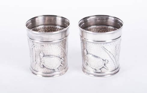A Pair of Tiffany & Co. Sterling Silver Turtle Cups: A Pair of Tiffany & Co. Sterling Silver Turtle CupsNew York, the pair of sterling silver beakers each having one turtle amongst reeds against a hammered ground. 10.98 total troy ounces.Provenance: The