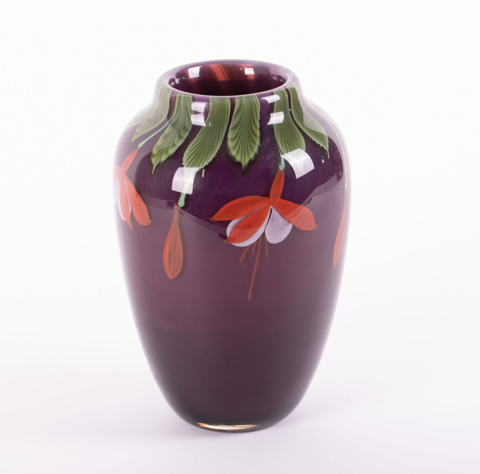 A Studio Paperweight Art Glass Vase, Bruce Sillars for Orient & Flume: A Studio Paperweight Art Glass Vase, Bruce Sillars for Orient & FlumeChico CA, 1983, a heavy purple ground vase with blooming Fuchsia around the top and draping down the vase. Signed B. Sillars Orient