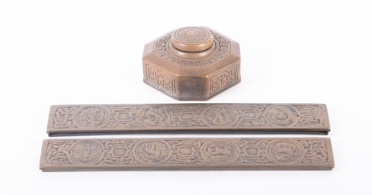 A Tiffany Studios Bronze Zodiac Pattern Inkwell and Desk Blotter Ends