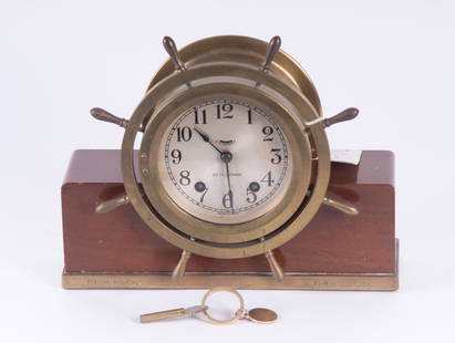 Seth Thomas Yacht Wheel Ships Bell Clock: Seth Thomas Yacht Wheel Ships Bell ClockHaving a nickel brass case, the clock having a Deco inspired wood base. Engraved to base High Rock Hopewell Jamaica 1956.From the collection of Richard Langer.H