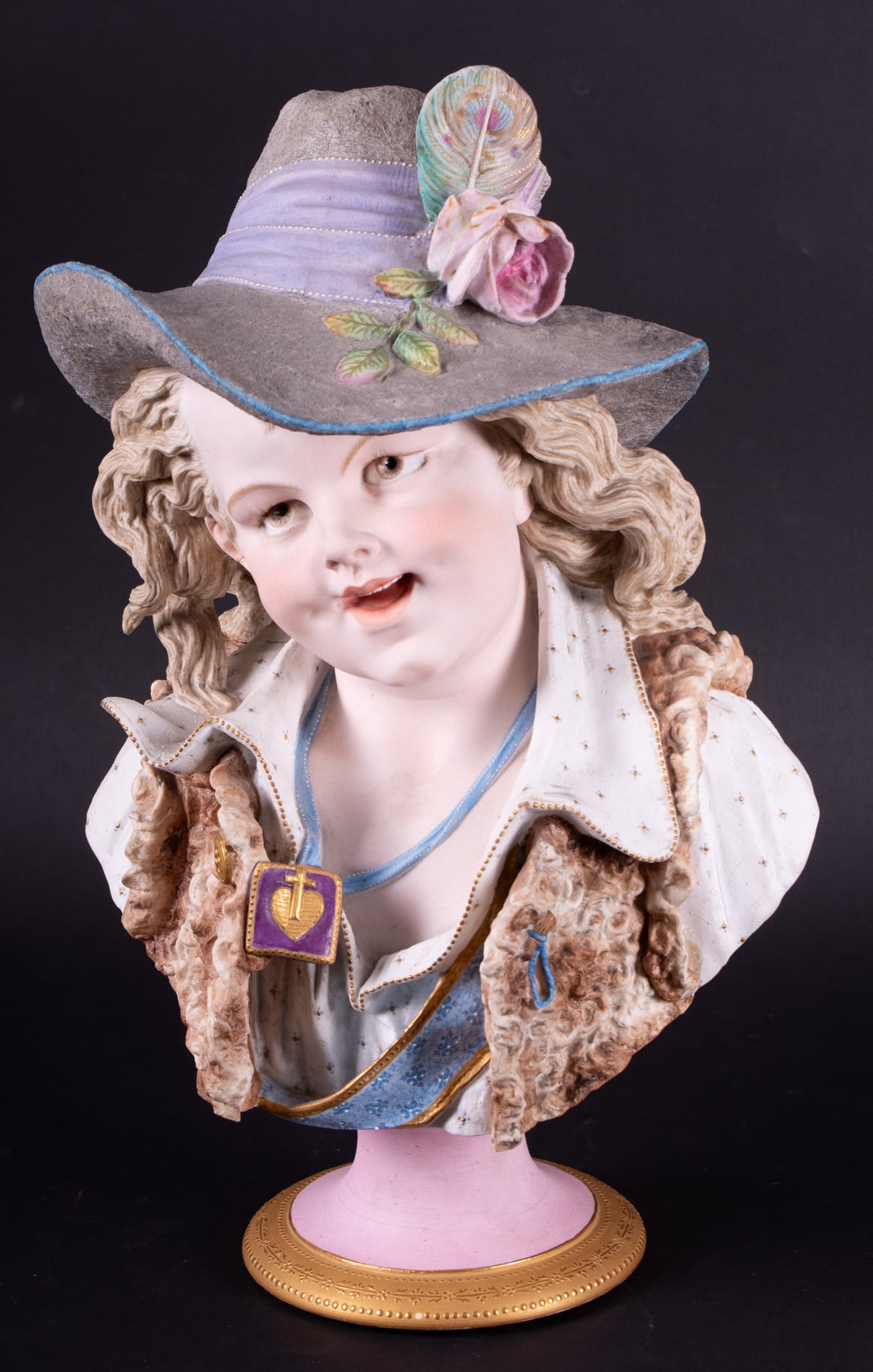 A Fine French Painted Bisque Bust of a Boy: A Fine French Painted Bisque Bust of a BoyFrance, 19th century, a finely detailed and painted bust of a young boy with long hair and fancy hat.Signed on verso Lemaire for Hector Lemaire (1846-1933).19