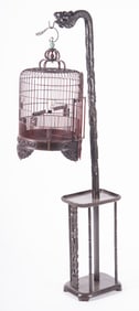 An Elaborately Carved Chinese Wood Bird Cage with Stand