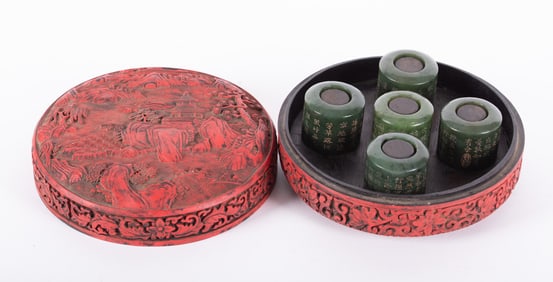 A Set of Five Spinach Green Jade Archer Rings in a Carved Cinnabar Box