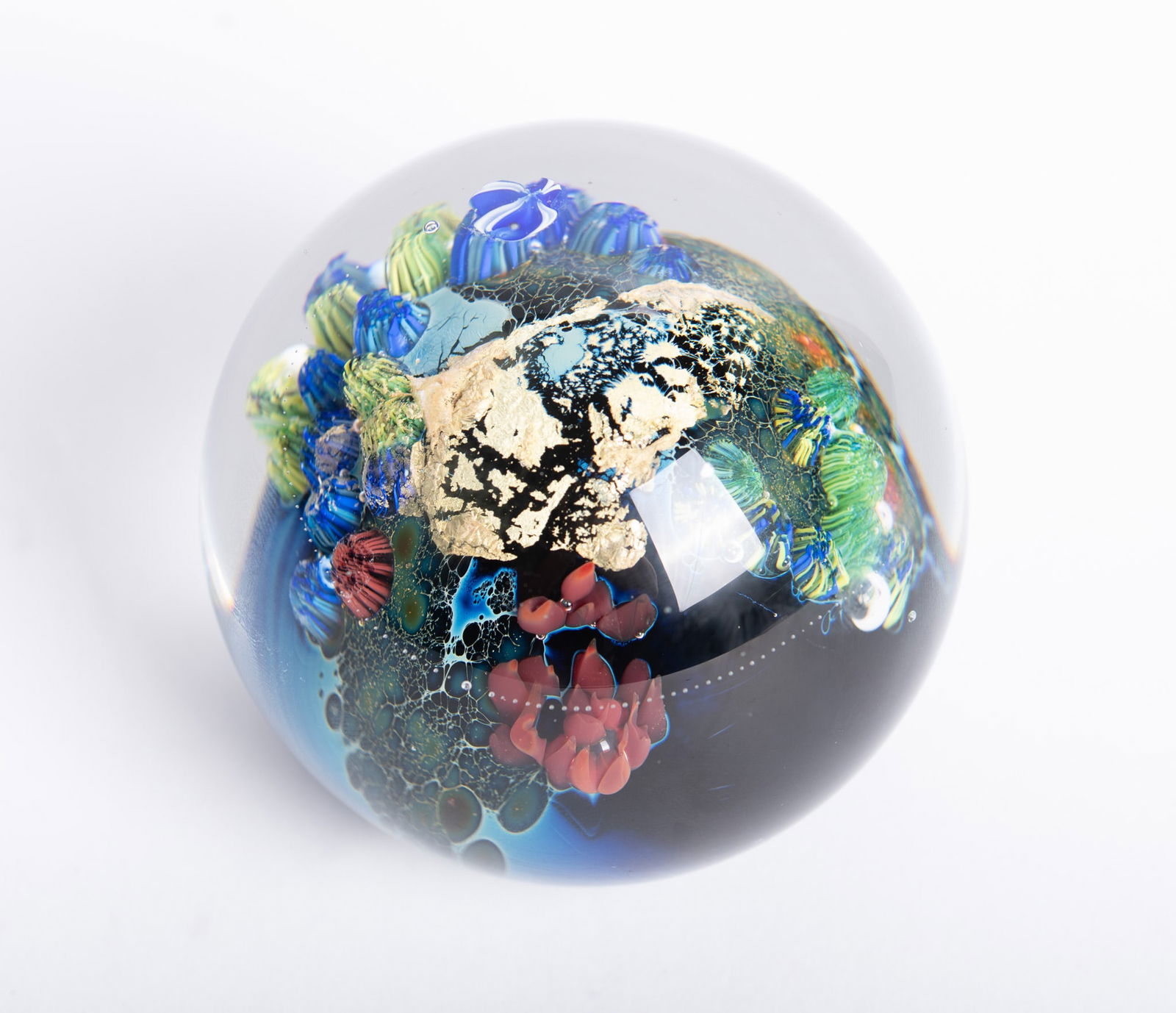 A Josh Simpson Inhabited Planet Paperweight: A Josh Simpson Inhabited Planet Paperweight1994, a colorful paperweight inspired by the story of Apollo astronauts seeing the earth hanging like a blue marble in space, script signature to base: Simps