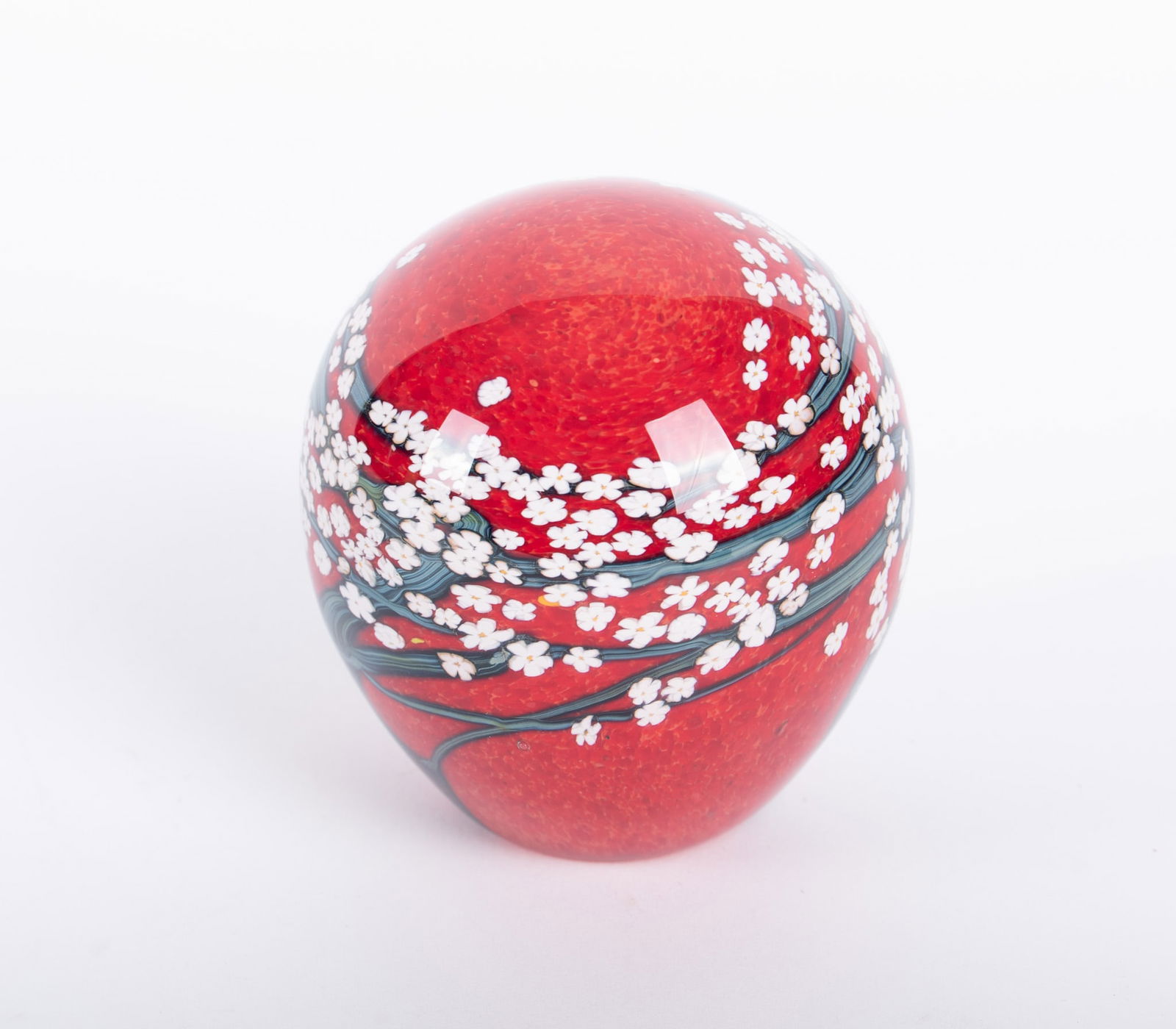 Peter Raos Red Ground Art Glass Paperweight 2004: Peter Raos Red Ground Art Glass Paperweight 2004New Zealand, a domed art glass paperweight depicting white blossoms on woody prunus branches full round, over a deep red ground, signed Peter Raos 2004