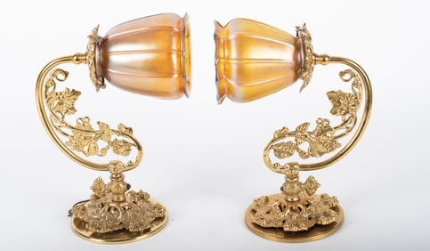 A Pair of One-Arm Wall Sconces with Quezal Shades
