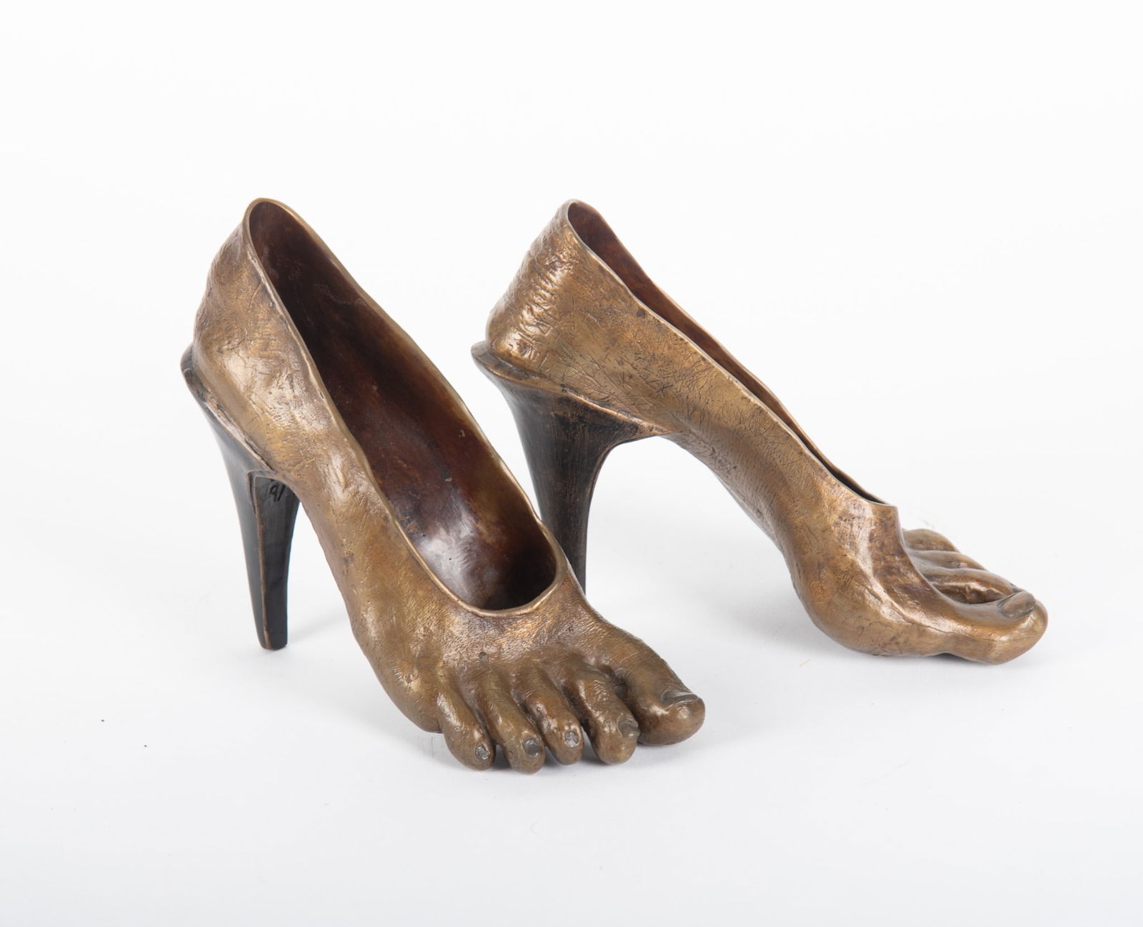 Bronze High Heeled Feet by Clee Richeson: Bronze High Heeled Feet by Clee RichesonA pair of these fun high heels by Clee Richeson are on permanent display at Art on the Corner - Grand Junction. CO. They measure 5 1/2 inches tall by 8 inches l