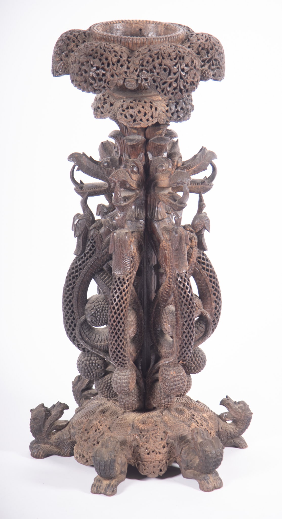 An Exotic Anglo-Indian Carved Urn Stand: An Exotic Anglo-Indian Carved Urn Stand An Anglo-Indian Bombay blackwood, intricately carved and pierced, urn or plant stand jardiniere with overhanging scalloped apron resting on a column formed by s