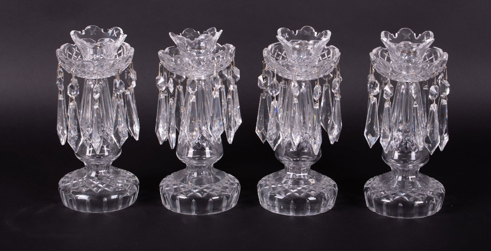 Four Waterford Crystal Candlesticks: Four Waterford Crystal Candlesticks20th century, a matched set of 4 signed Waterford candlesticks with prisms.10 1/4 inches tall, 4 1/2 inches diameter