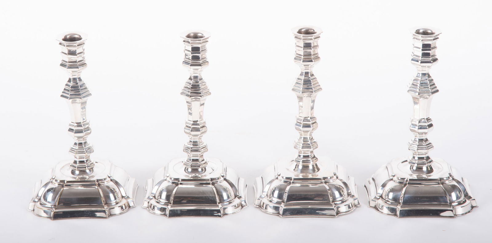 A Matched Set of Four 18th Century Style Plated Silver Candlesticks: A Matched Set of Four 18th Century Style Plated Silver CandlesticksIn the 18th century manner, a good set of four plated silver sticks, unmarked.8 3/4 inches tall, 4 1/2 inch base