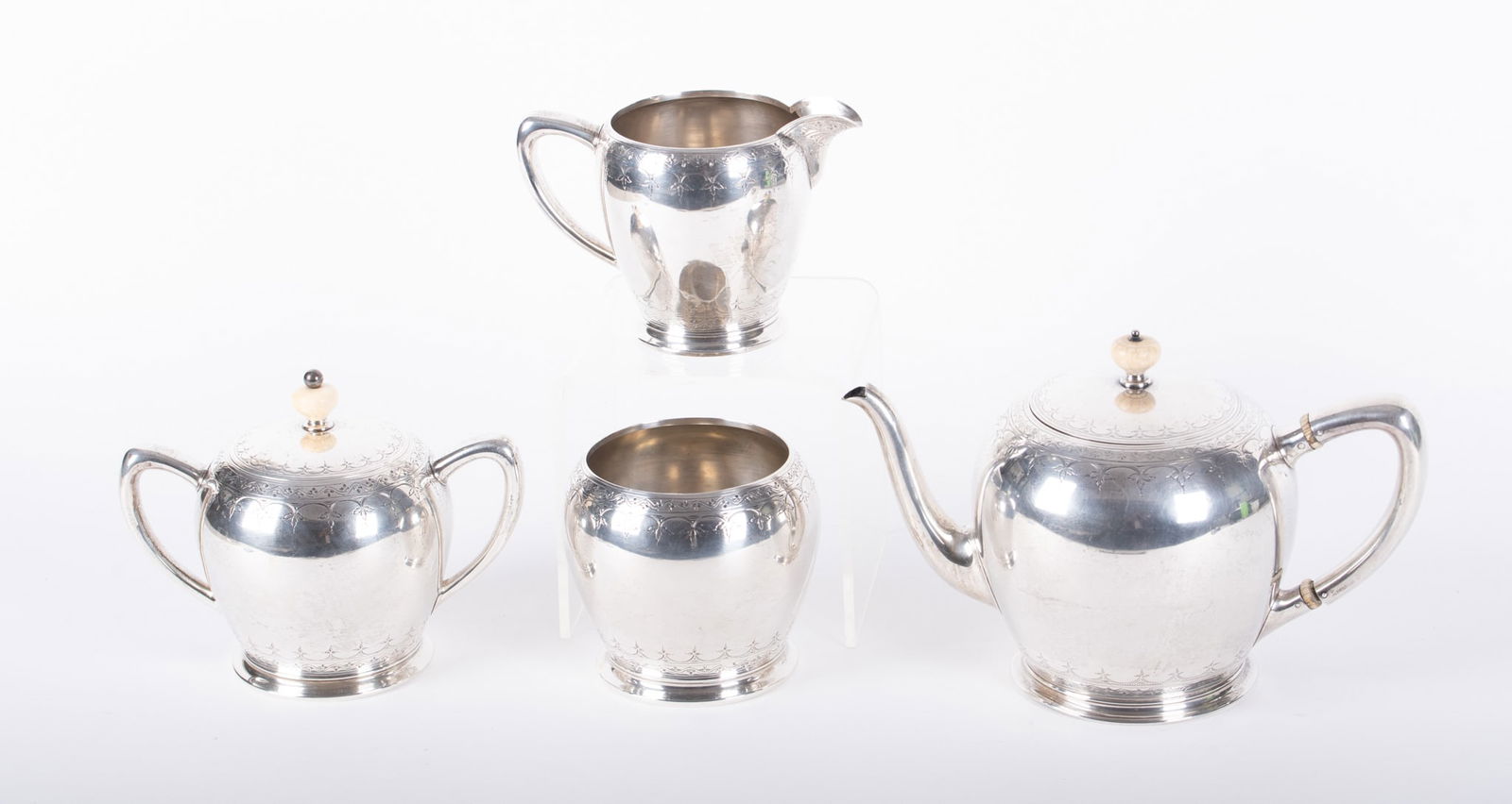 An Edwardian Style Sterling Silver Tea Service, Lebkuecher and Company: An Edwardian Style Sterling Silver Tea Service, Lebkuecher and CompanyNew Jersey, retailed by F.W. Drosten Jewelry Co. St. Louis, a 4-piece sterling silver service including a teapot, covered sugar, c