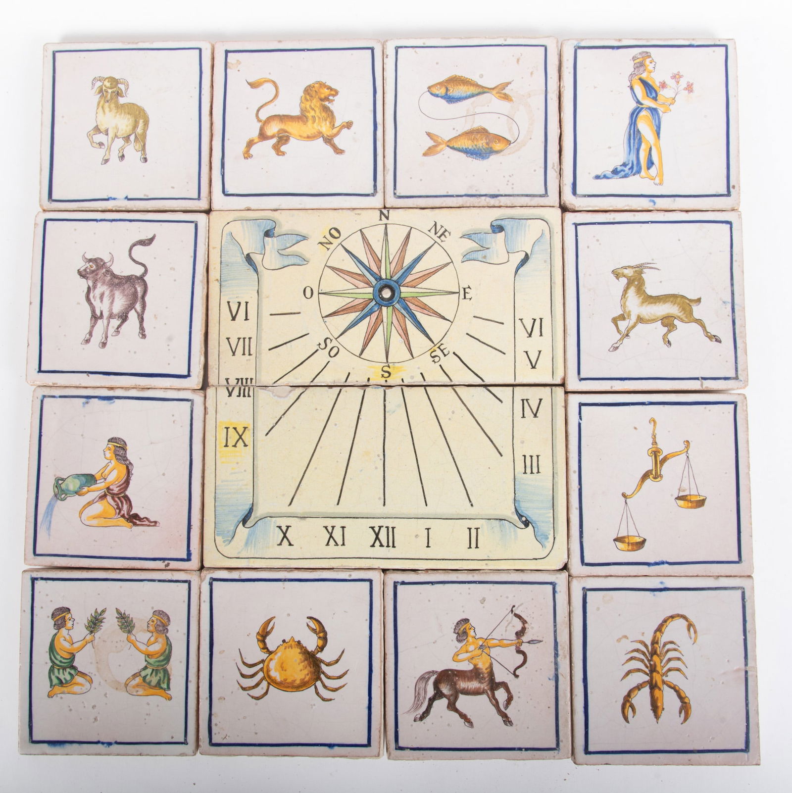 Zodiac Painted Tiles: Zodiac Painted Tiles14 tiles making up the zodiac. The twelve pictorial tiles surround two larger pieces with a sundial design.Provenance: The Estate of Diana Eley, St. Louis, MO11 x 5 1/2 inches (lar