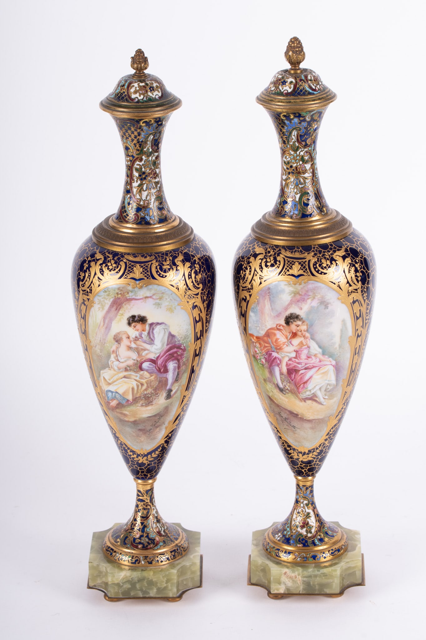A Pair of French Sevres Porcelain and Champleve Enamel Lidded Vases: A Pair of French Sevres Porcelain and Champleve Enamel Lidded VasesFrance, late 19th/early 20th century, a pair of fine covered vases or urns, the plinth of shaped green onyx, having champleve enamel