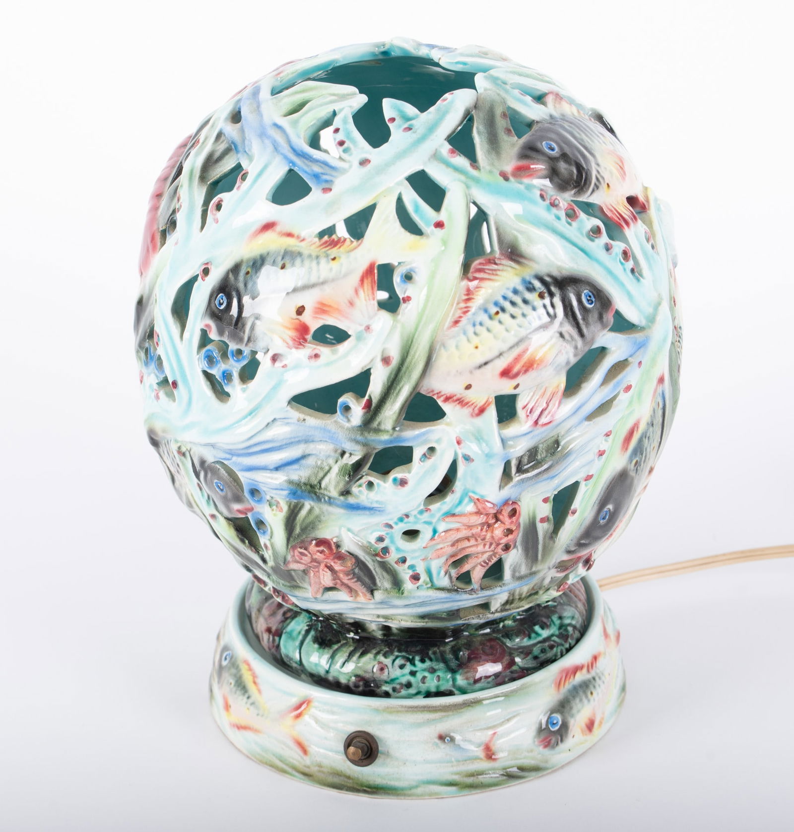 A Vintage Italian Pottery Lamp with Fish and Sea Creatures: A Vintage Italian Pottery Lamp with Fish and Sea CreaturesAn unusual Majolica style lamp having a pierced pottery shade with numerous creatures from the sea, marked 2287 Italy.Provenance: The Estate o