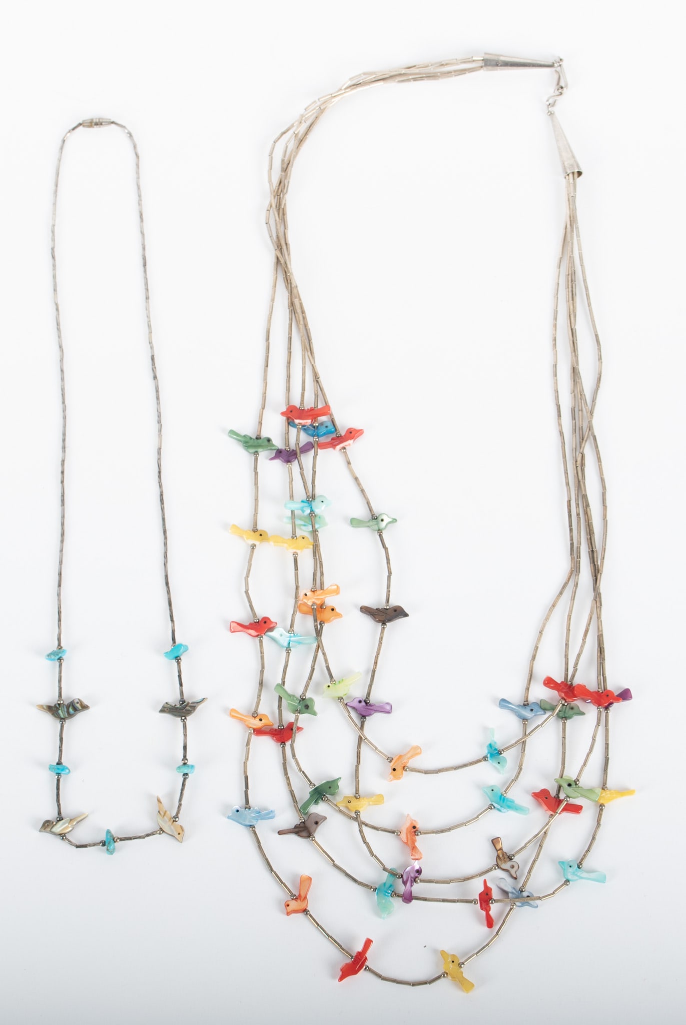 Native American Five Strand Fetish paired with a Single Strand: Native American Five Strand Fetish paired with a Single StrandThe five strand fetish has multiple colored mother of pearl birds. Graduated, with the shortest strand being 25 inches. The single strand