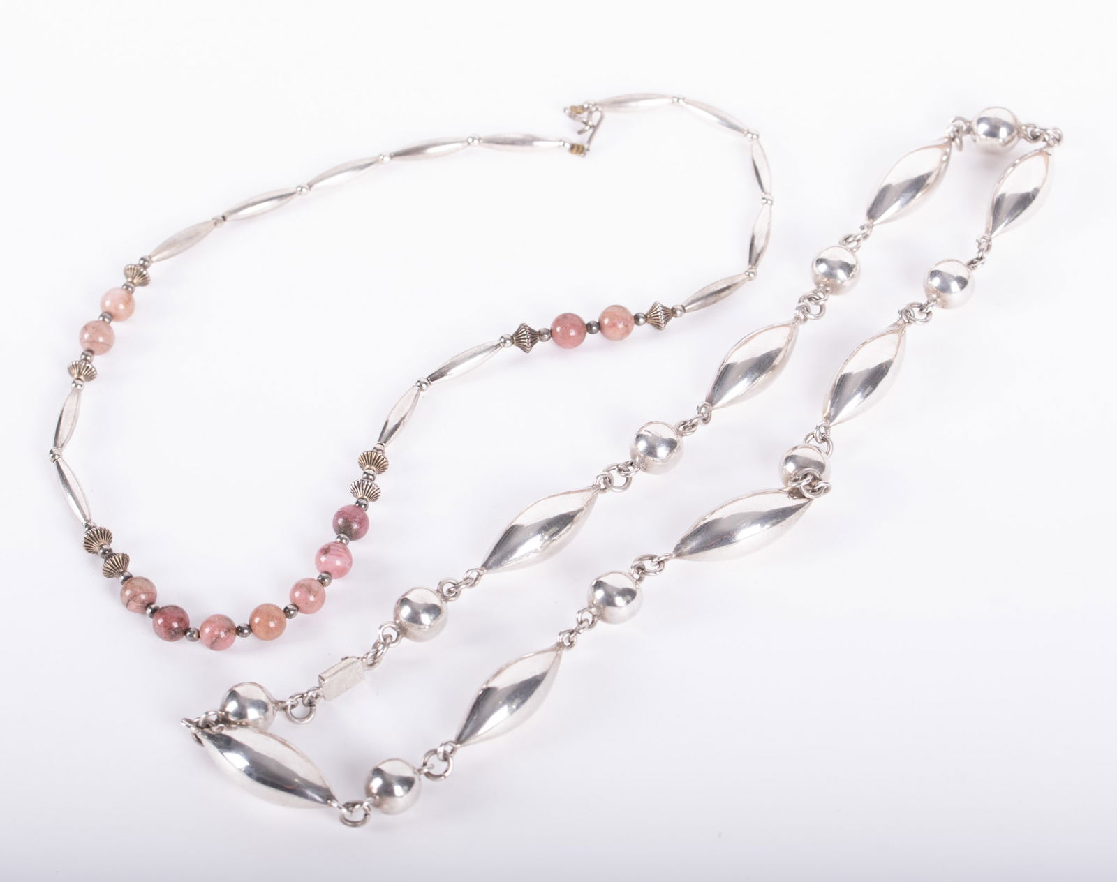 Vintage Mexican Sterling Necklace paired with a Sterling Rhodonite Necklace: Vintage Mexican Sterling Necklace paired with a Sterling Rhodonite NecklaceThe torpedo style necklace 24 inches long and weighs 62.2g. The sterling necklace with rhodonite beads is 20 inches long and