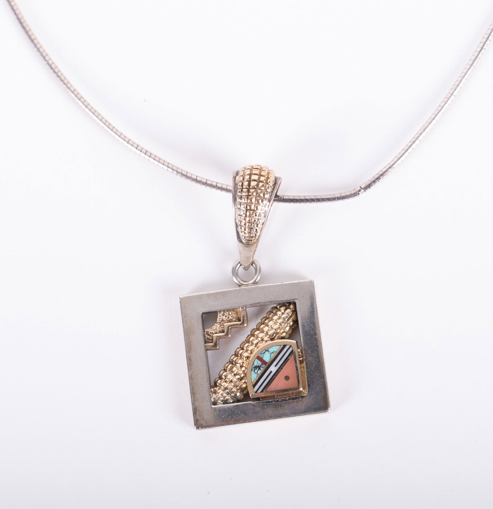 Fabulous 14K Yellow Gold & Sterling Pendant by Ray Tracey: Fabulous 14K Yellow Gold & Sterling Pendant by Ray Tracey This pendant showcases a small inlaid piece set with turquoise, rhodonite, black jade and bone. It comes with a sterling wire. Weight