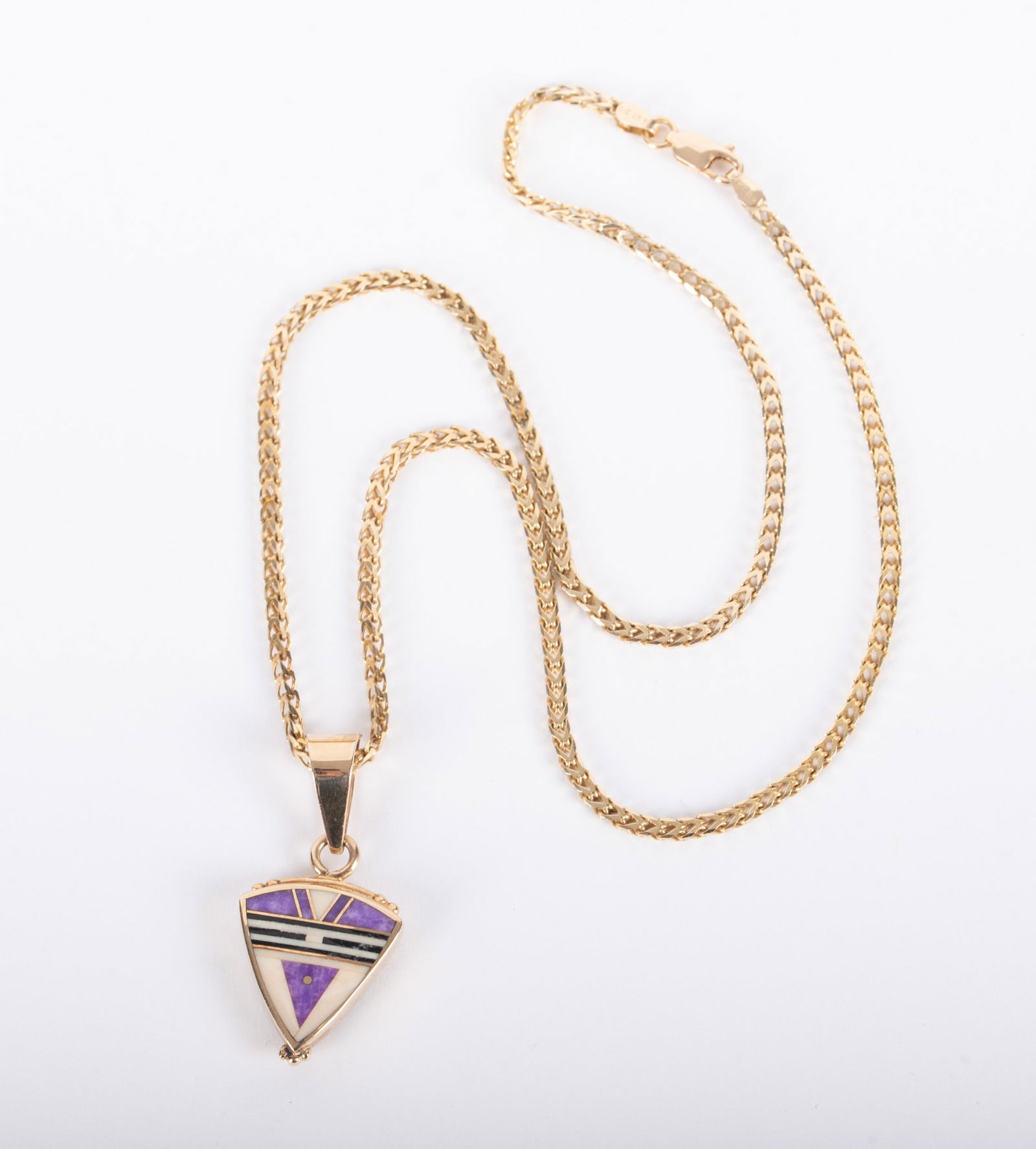 14K Yellow Gold Inlaid Pendant by Ray Tracey along with a 14k Chain: 14K Yellow Gold Inlaid Pendant by Ray Tracey along with a 14k Chain The signed pendant is inlaid with spiny oyster, malachite, black jade and bone. The reverse is inlaid with sugilite, bone and black