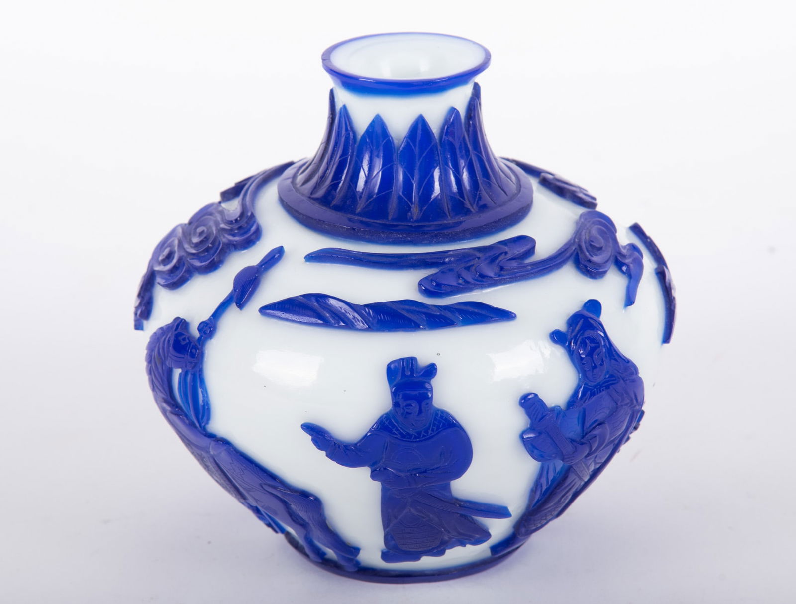 A Chinese Blue and White Peking Glass Vase: A Chinese Blue and White Peking Glass Vase China, 20th century, a deeply cut-back cobalt blue to white Peking glass vase having two elders besides a horse with floral and mountainous designs. 5 1/2