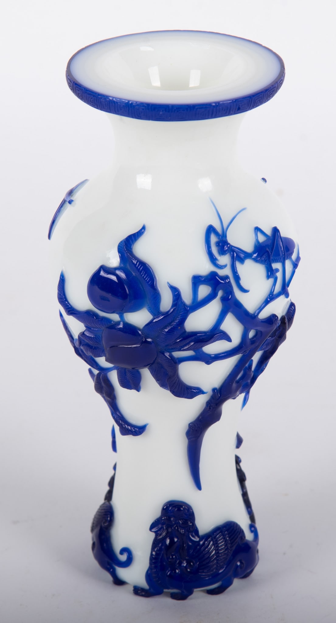 A Good Chinese Blue and White Peking Glass Vase: A Good Chinese Blue and White Peking Glass Vase China, the finely detailed blue overlay depicting peach tree branches with a perched praying mantis and hovering dragon flies. The vase's base