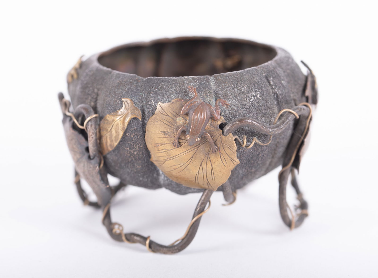 A Fine Japanese Mixed-Metal Okimono of a Lotus Bloom: A Fine Japanese Mixed-Metal Okimono of a Lotus Bloom Japan, Meiji period, a charming and well crafted diminutive mixed-metal sculpture of a lotus, the exterior of the round and footed vessel