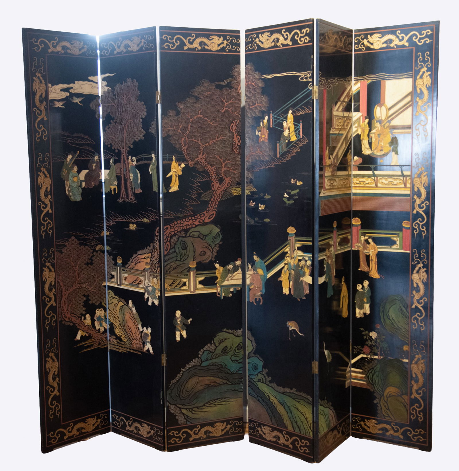 Six Panel Coromandel Room Screen: Six Panel Coromandel Room ScreenBlack lacquered panels that have been carved and painted. One side features scenes of people and landscapes with a border of a dragon, the other side has panels of flor