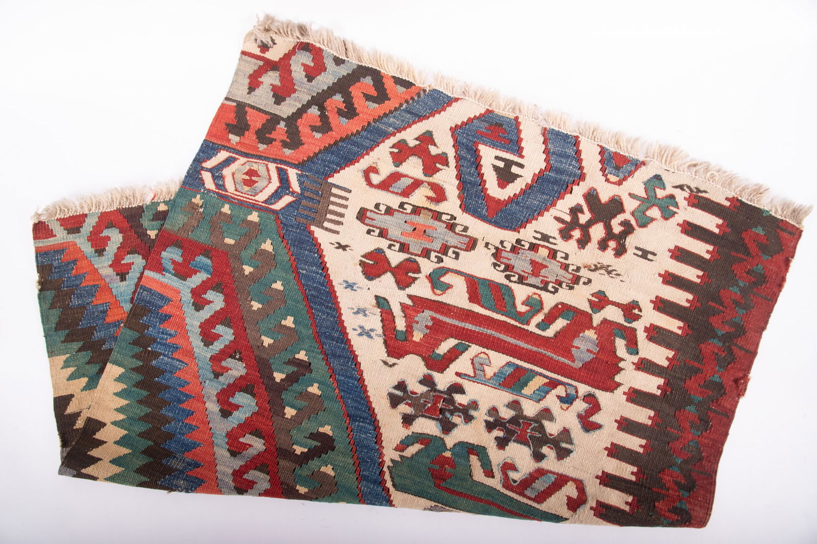 Hand Knotted Kilim Accent Rug: Hand Knotted Kilim Accent Rug A partial from a larger Kilim made into a smaller area rug. Geometric designs with strong earthy tones. Fringe edges. 39 x 31 inches; 3'3" x 2'7"