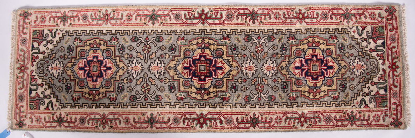 Handwoven Persian Serapi Runner: Handwoven Persian Serapi Runner Three matching medallions in dark blue, red and ivory with a floral field throughout all centering stepped spandrels and geometric and floral border. 2' 6" x 7' 10"
