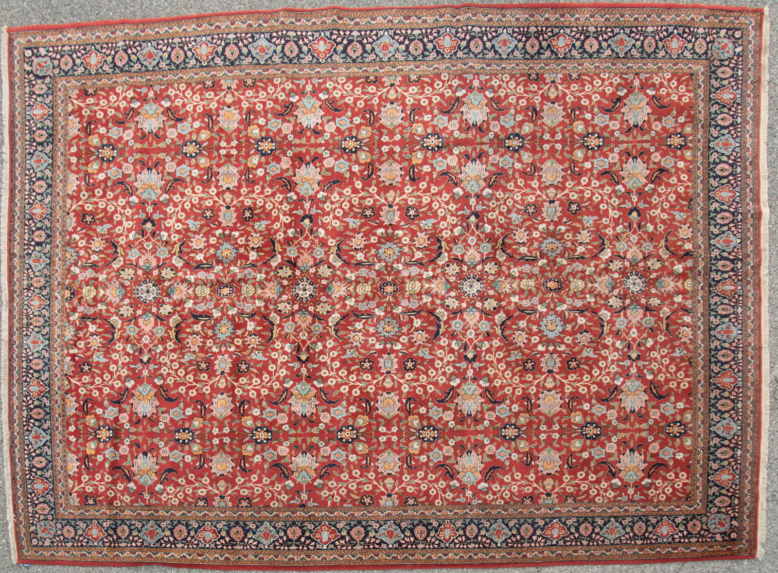 Finely Handwoven Turkish Tabriz Design: Finely Handwoven Turkish Tabriz Design All over floral designs with navy blue border. 9' 5" x 12' 7"