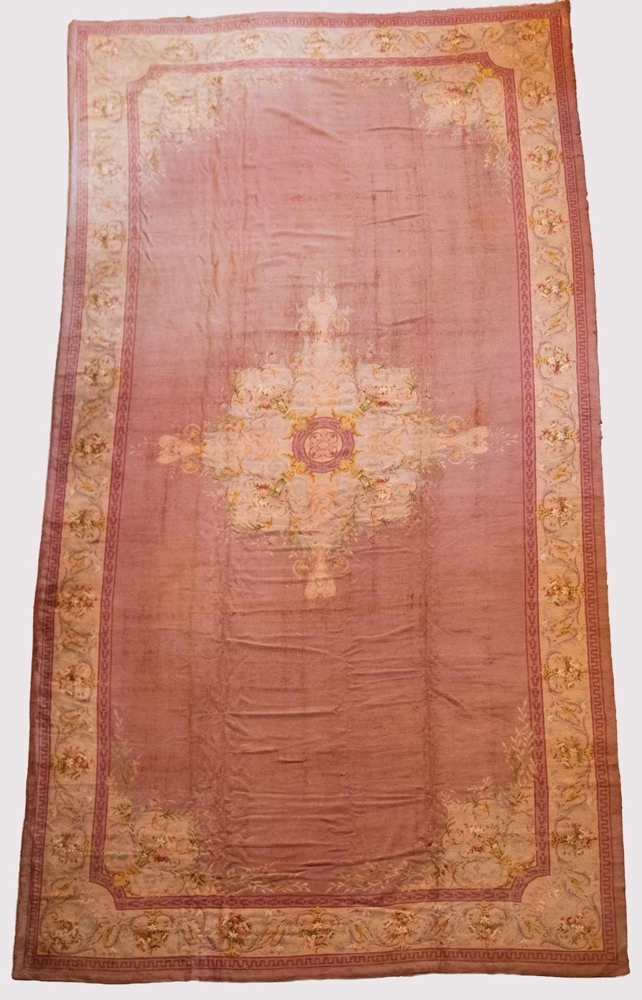 Semi Antique Handwoven Savonnerie Room Rug: Semi Antique Handwoven Savonnerie Room Rug Large center medallion of scrolliing and foliate designs in shades of gold, blue, cream and green all withing a large salmon shaded field with matching