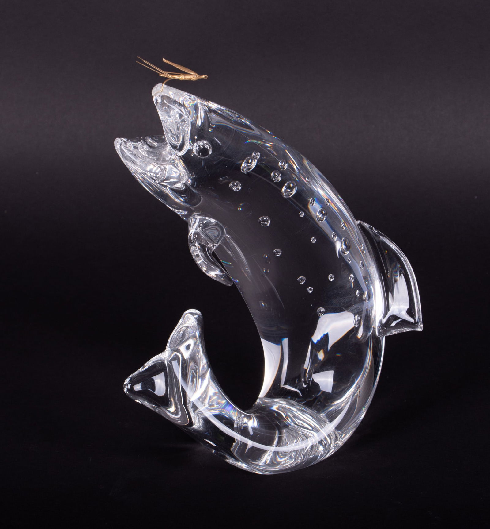 A Crystal Trout with 18K Fly, James Houston for Steuben: A Crystal Trout with 18K Fly, James Houston for SteubenCorning NY, from a 1966 design, the jumping trout catching the gold fishing fly on the upper lip, the body having internal bubble to represent wa