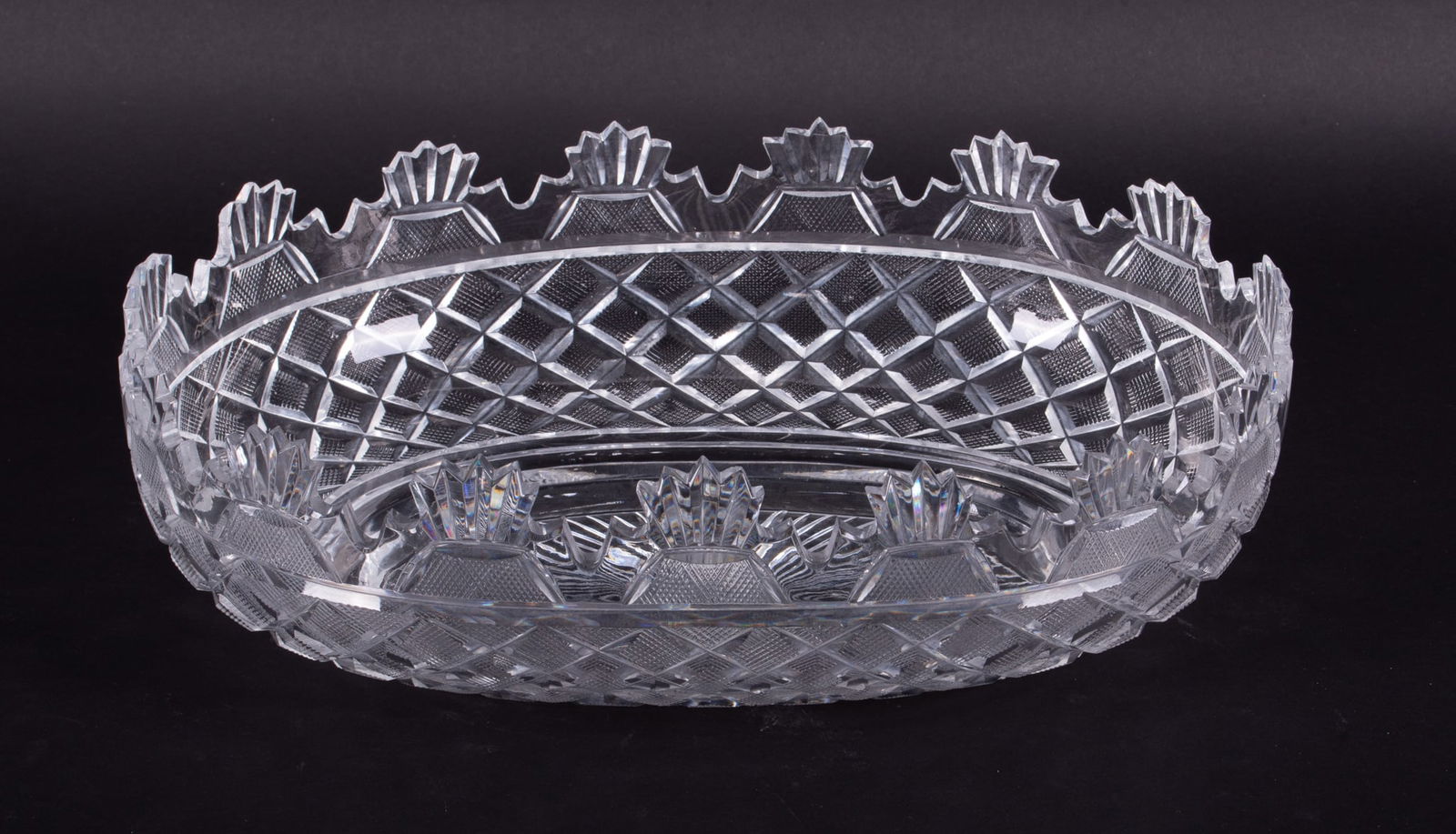Waterford Crystal Heritage Collection Kennedy Centerpiece Bowl: Waterford Crystal Heritage Collection Kennedy Centerpiece BowlA nice centerpiece oval bowl with a rim of fans and arches sharply beveled above crisp diamond faceted panels. Starburst base with Waterfo