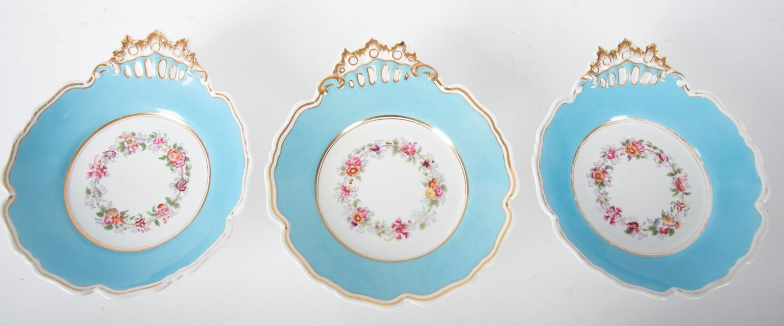 Three English Chamberlains Worcester Dessert Compotes: Three English Chamberlains Worcester Dessert CompotesEngland, 19th century, three asymmetrically shaped footed compotes, each having a wide turquoise band with gold gilt highlights, the compote's well