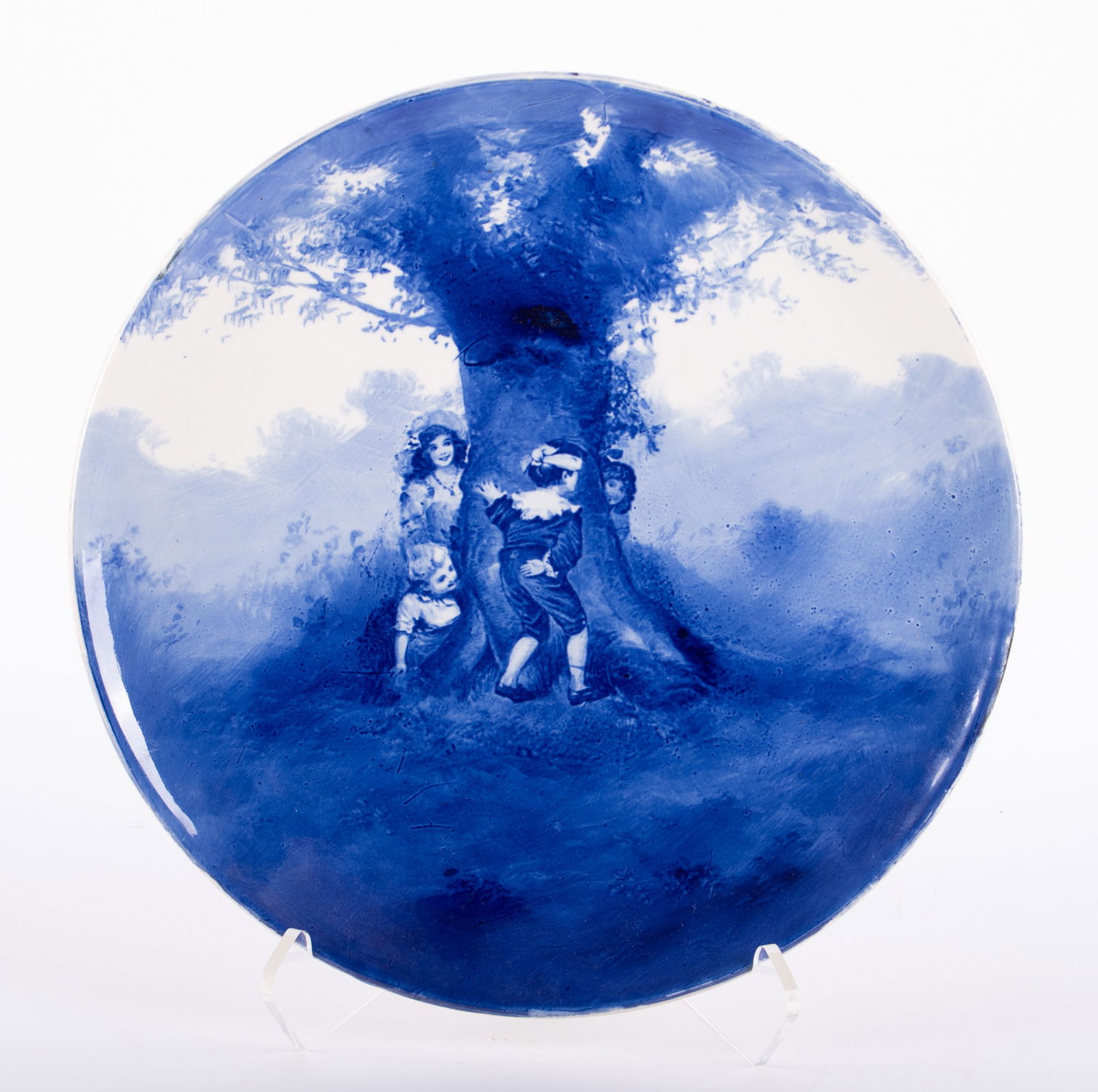 A Royal Doulton Flow Blue Charger, Blind Man's Bluff: A Royal Doulton Flow Blue Charger, Blind Man's Bluff England, early 20th century, part of the Babes in the Woods flow blue series by Doulton, the charger with children playing Blind Man's Bluff. 15