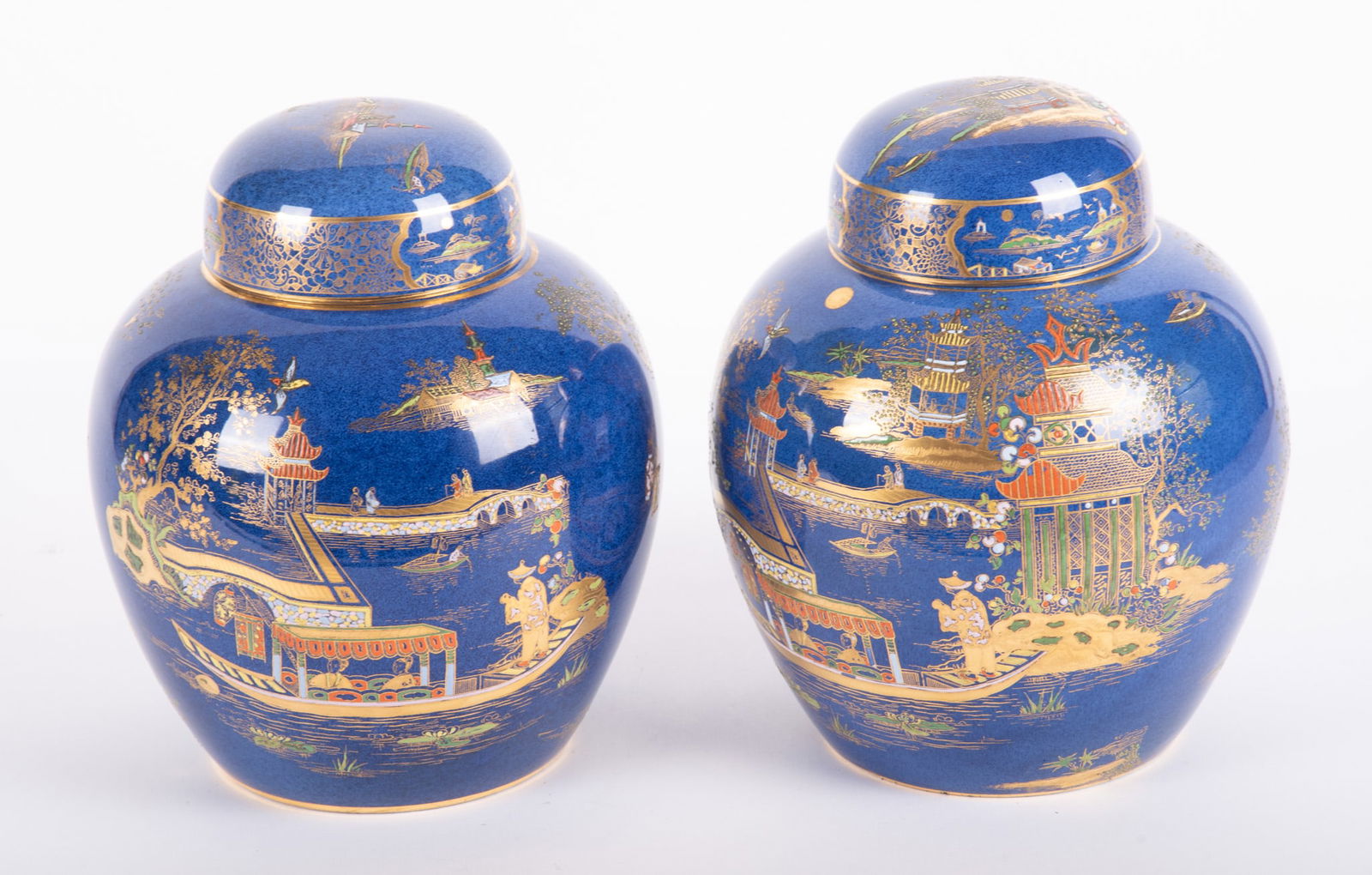 Pair of Large Carltonware Pagoda Ginger Jars: Pair of Large Carltonware Pagoda Ginger JarsStoke on Trent, England, W&R mark for Wilshaw & Robertson, pair of blue ground Chinoiserie style lidded jars with gilt and enamel decorations.10 inches tall