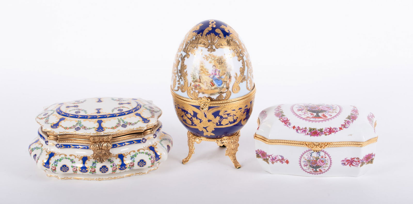 Three Large French Gilt Metal Mounted Porcelain Boxes: Three Large French Gilt Metal Mounted Porcelain BoxesFrance, late 20th century, a large Limoges egg-form hinged box with heavy gold gilt on a cream and cobalt ground (10 1/4 inches tall); a hinged top