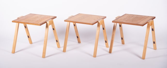 A Set of Three Blonde Wood Stackable Tables