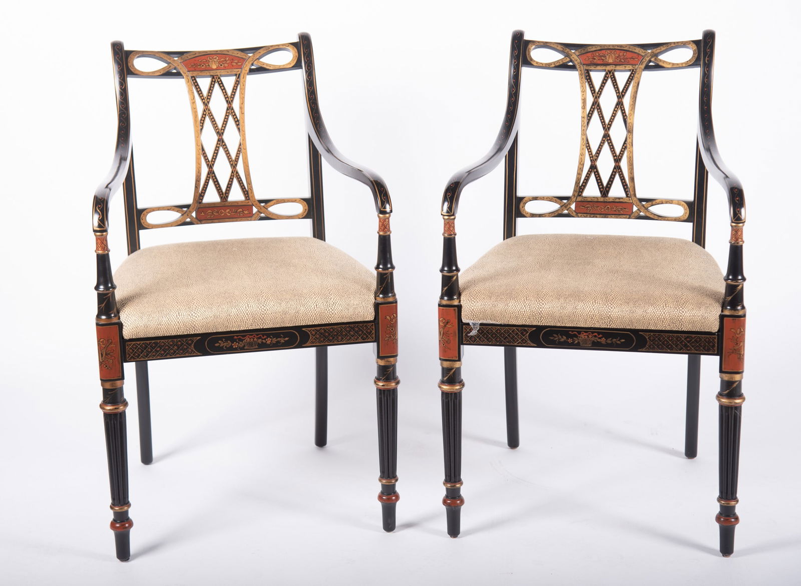 Pair of French Regency Arm Chairs: Pair of French Regency Arm Chairs Southwood Furniture Co. pierced back splat with gilt highlights above a snakeskin pattern upholstered seat resting on fluted tapering legs with painted highlights.