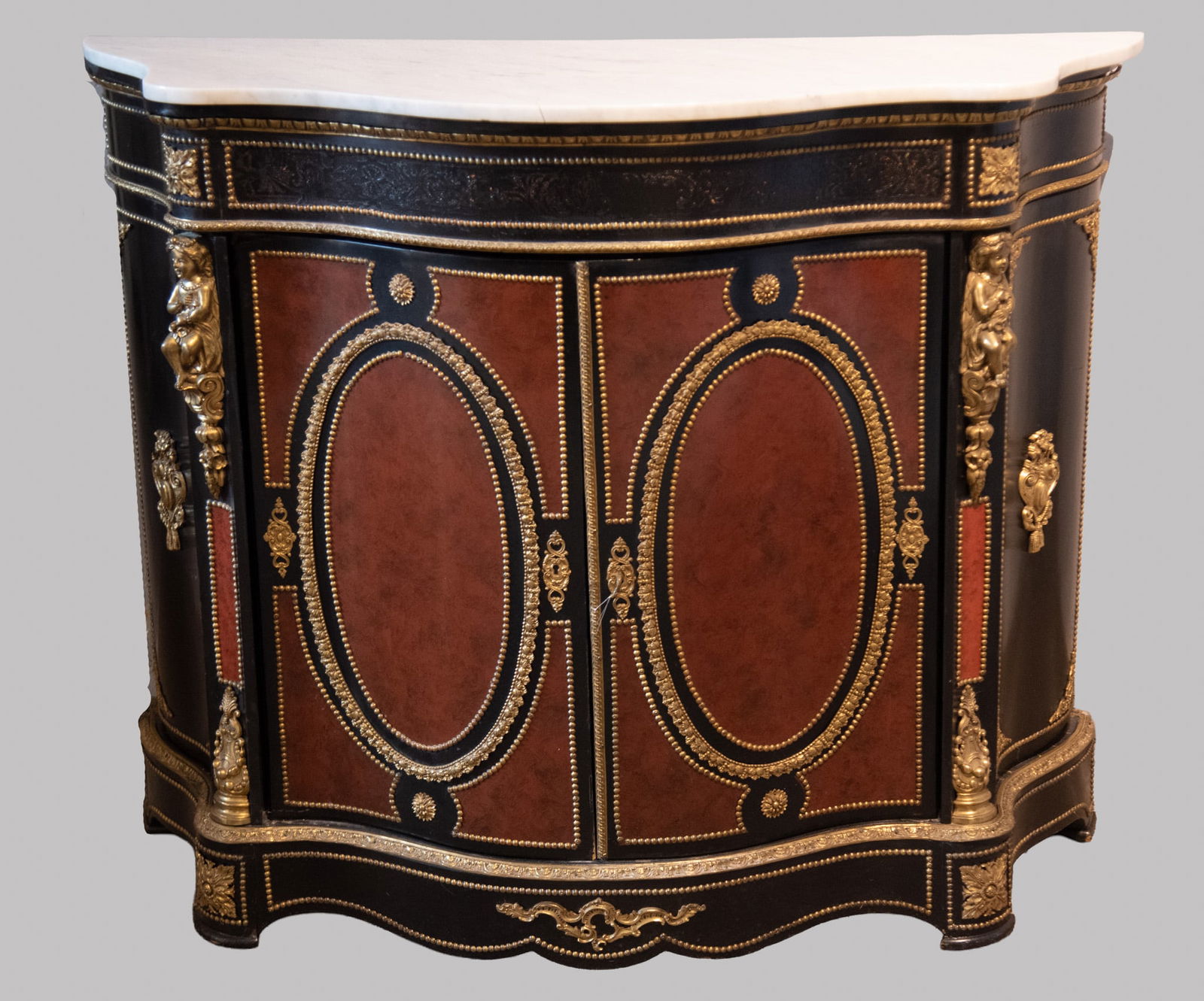 Semi Antique Napoleon III Boulle Side Cabinet: Semi Antique Napoleon III Boulle Side Cabinet Serpentine white marble top above a black and red lacquer conforming body having gadrooning along with a pair of doors with circular Boulle panels