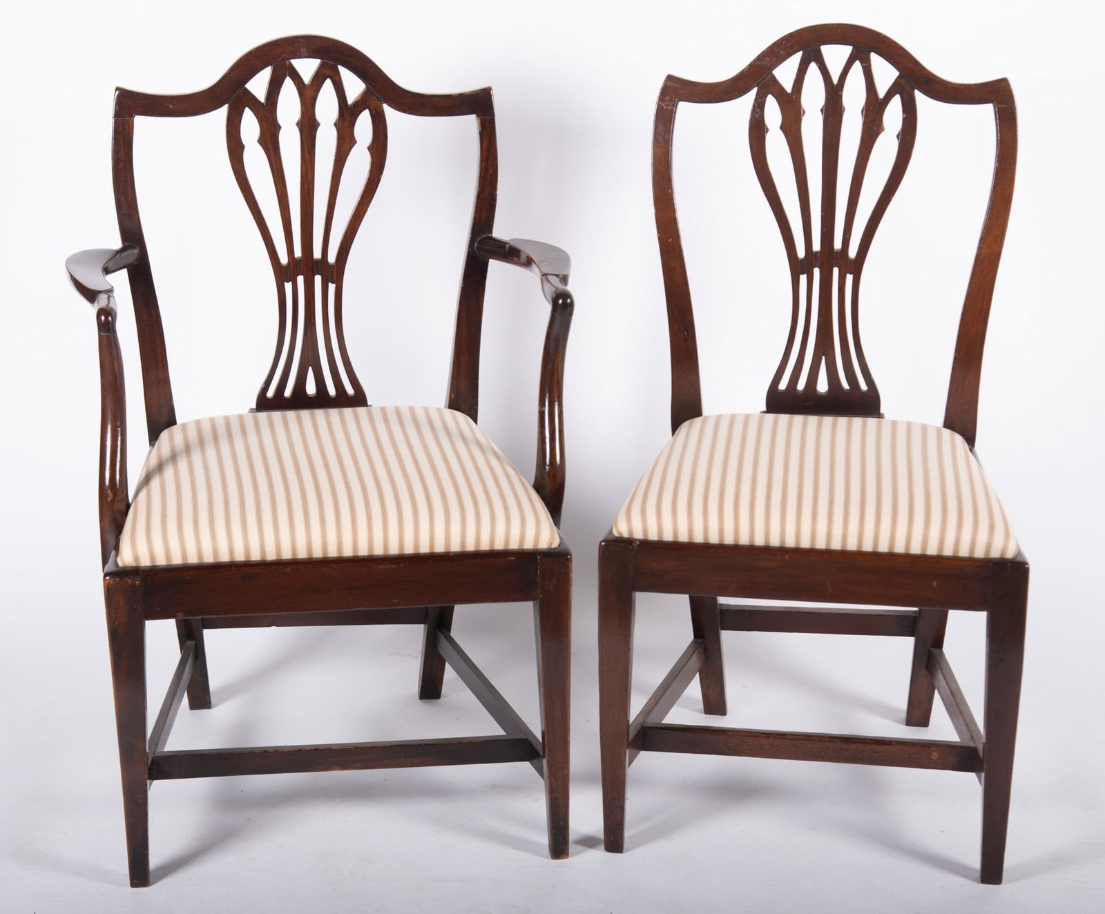 Set of Eight Federal Mahogany Hepplewhite Dining Chairs: Set of Eight Federal Mahogany Hepplewhite Dining Chairs Serpentine head rails above a pierced fan form back rest and striped upholstered seats on straight legs and stretchers. Two arm chairs and six