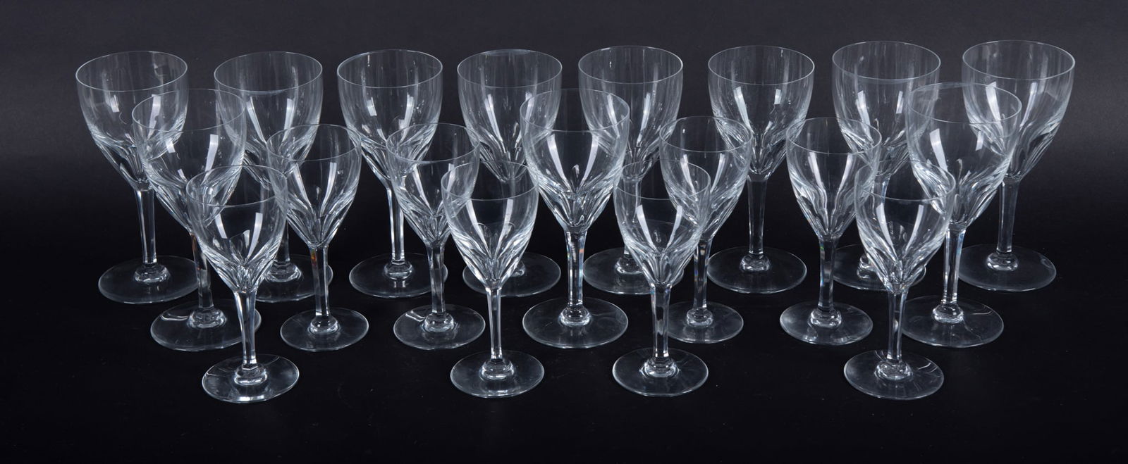 A Collection of Baccarat Panel Cut Red and White Wine Goblets: A Collection of Baccarat Panel Cut Red and White Wine GobletsFrance, late 20th century, a set of 11 White Wine goblets and 8 Red Wine goblets in a heavy cut panel cut to the goblet's bowl. Baccarat ac