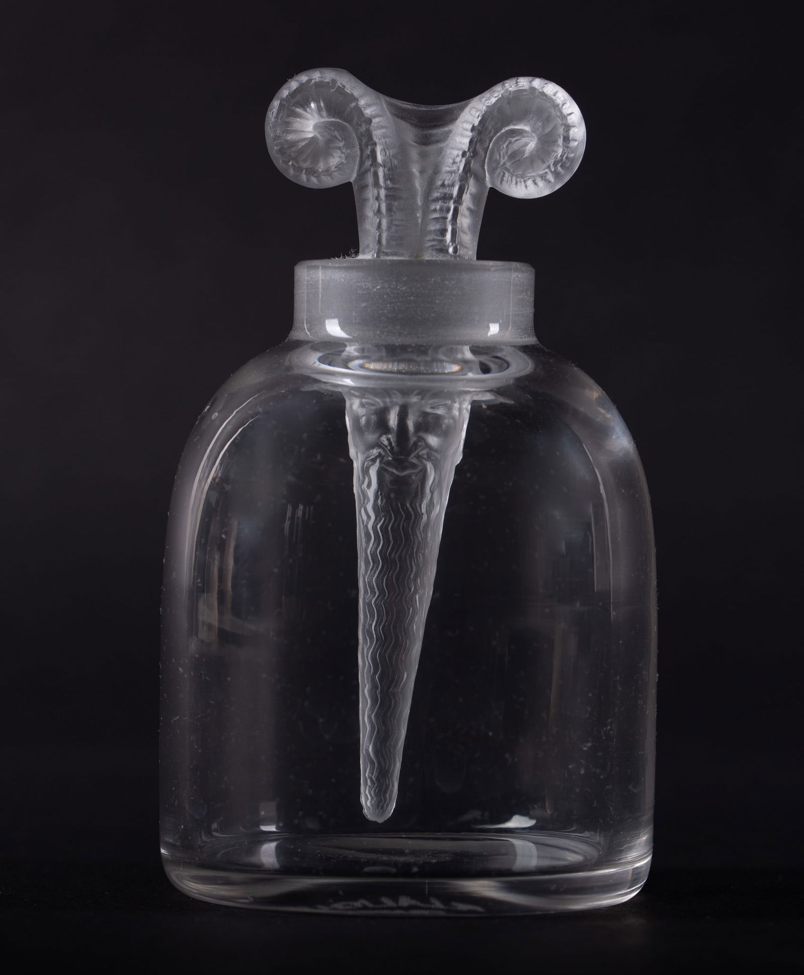 A Rare Rene Lalique Satyr Perfume Bottle: A Rare Rene Lalique Satyr Perfume Bottle France, design circa 1933, a clear and frosted scent bottle, the clear beehive shaped base marked R. Lalique France, the pointed frosted glass stopper having
