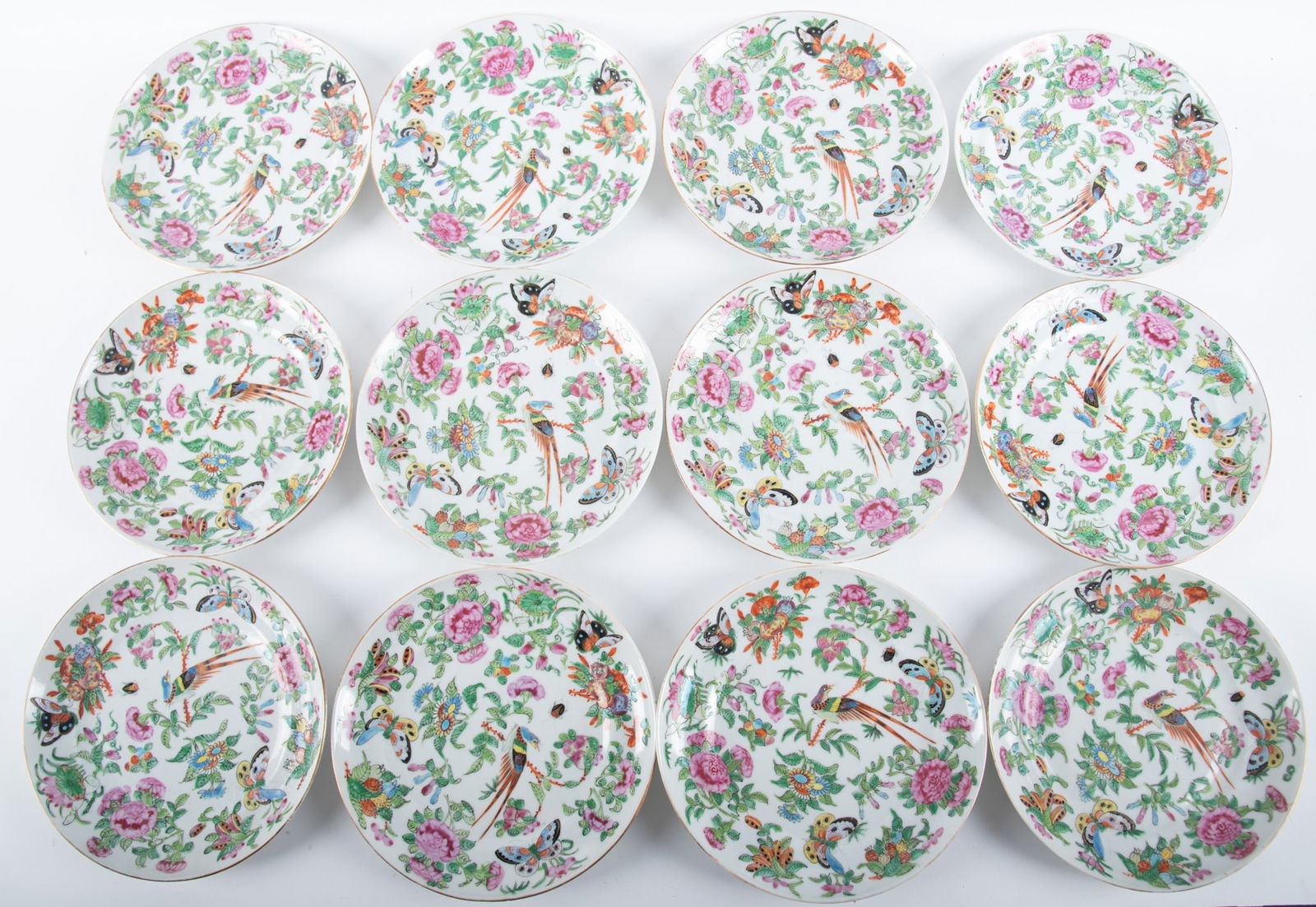 Twelve Chinese Export Famille Rose Plates: Twelve Chinese Export Famille Rose PlatesChina, late Qing, a set of 12 dinner plates, the surface lavishly decorated with 3 butterflies, an exotic pheasant and a single beetle, all amidst fruit and fl