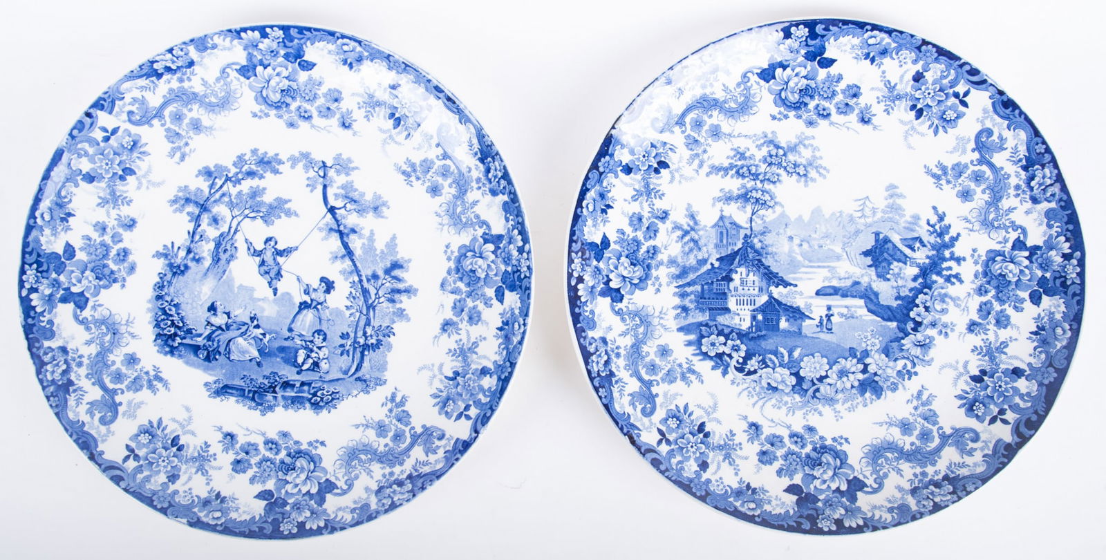 Two Antique Mintons Blue and White Porcelain Chargers: Two Antique Mintons Blue and White Porcelain ChargersEngland, late 19th century, the similar pair of 15" flow-blue Staffordshire platters, one featuring young children on a swing between trees, the ot