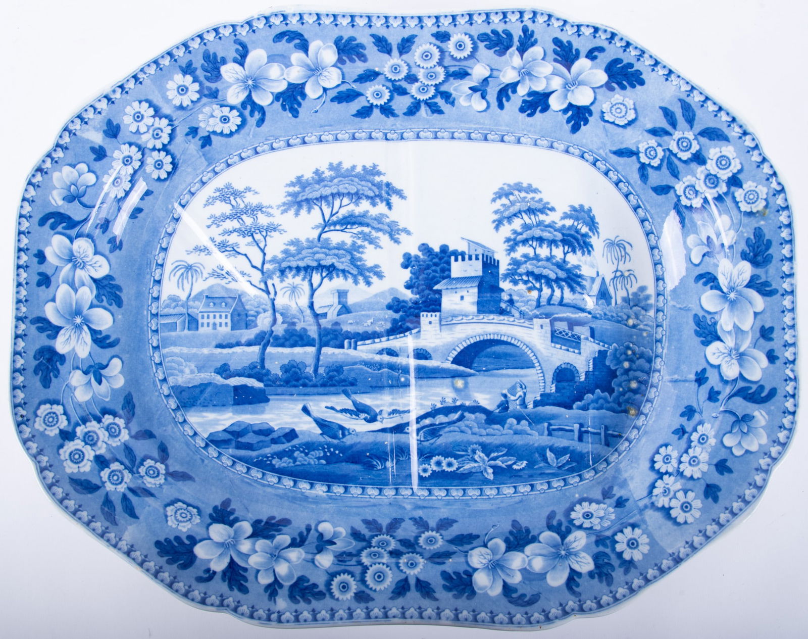 A Large Staffordshire Blue and White Platter, Old Tower by Spode: A Large Staffordshire Blue and White Platter, Old Tower by SpodeEngland, mid-19th century, a large and deep "tree in well" transferware platter, the blue and white pattern depicting fisherman amidst a
