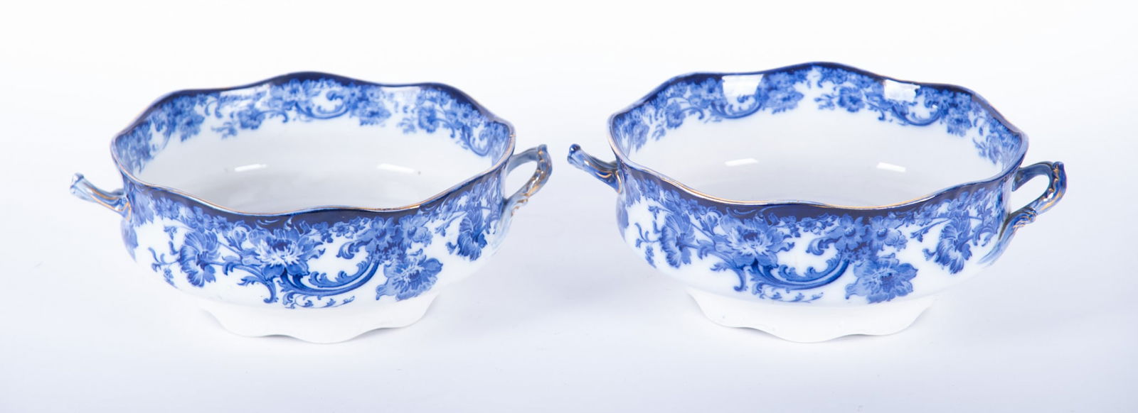 A Pair of Doulton Burslem Flow Blue Serving Bowls, Melrose Pattern: A Pair of Doulton Burslem Flow Blue Serving Bowls, Melrose PatternEngland, late 19th century, a pair of oversized 2-handle serving bowls or tureens, the scalloped rims and handles trimmed in gold gilt