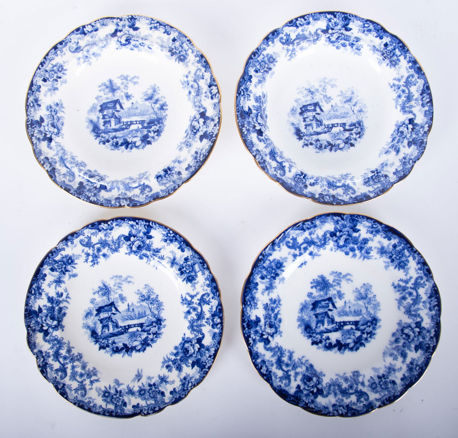 Four Dark Blue and Gilt Minton Genevese Pattern Dishes: Four Dark Blue and Gilt Minton Genevese Pattern Dishes England, late 19th century, the four gold gilt and scallop edge plates in the desirable Genevese pattern by Spode. A pair of 7 1/2 inch desert