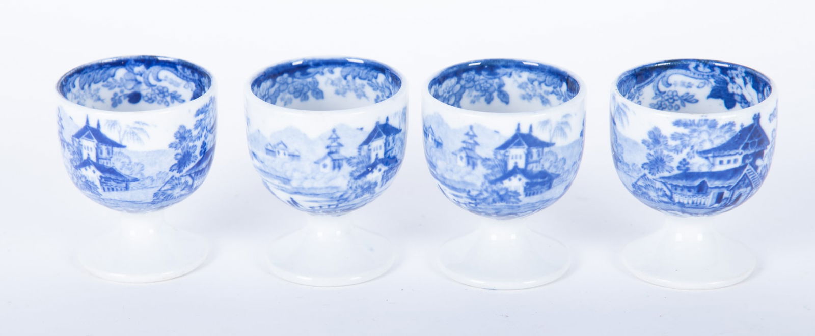 Four Antique Minton Genevese Pattern Egg Cups: Four Antique Minton Genevese Pattern Egg Cups England, late 19th century, a matched set of four egg cups in Minton's Genevese blue transferware pattern, the bowls of the cups are decorated in the