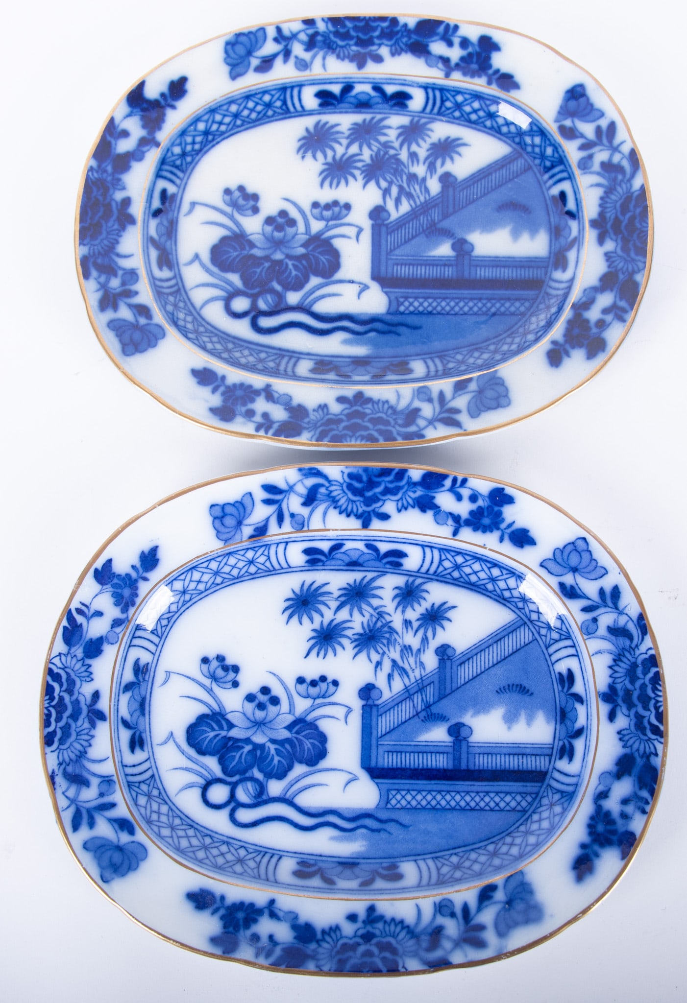 A Good Pair of Diminutive Flow Blue Serving Platters, Oriental by Samuel Alcock and Sons: A Good Pair of Diminutive Flow Blue Serving Platters, Oriental by Samuel Alcock and SonsStaffordshire England, a fine pair of platters in the Oriental pattern featuring trees and water botanicals near