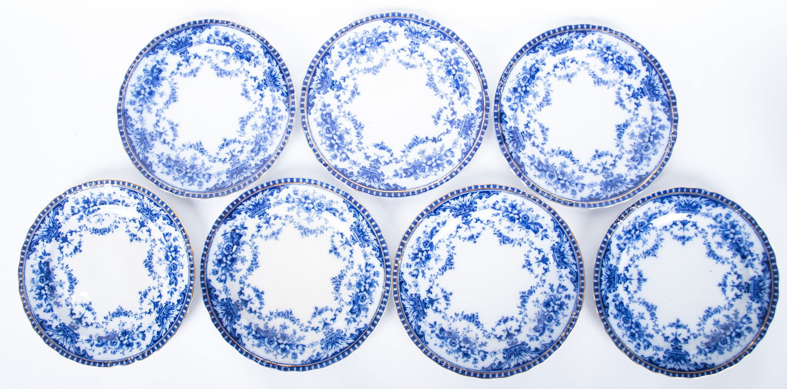 Seven Flow Blue 9 1/4 inch Plates, Coronet by Sampson Hancock and Sons: Seven Flow Blue 9 1/4 inch Plates, Coronet by Sampson Hancock and SonsStaffordshire, early 20th century, seven difficult to find dinner plates in the Coronet pattern, having scallop and gilt edge rim,
